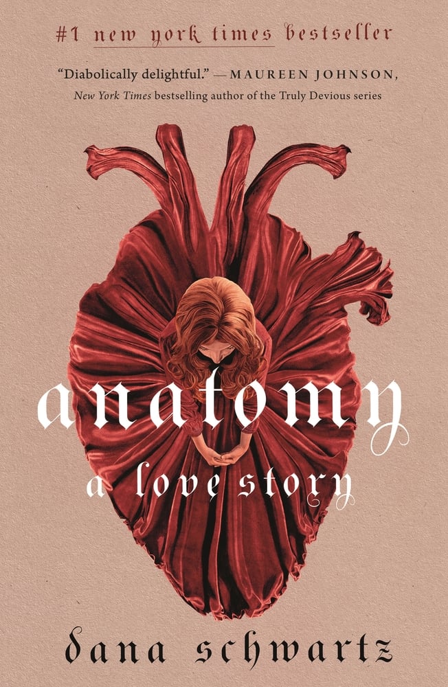 The book cover for Anatomy: A Love Story. A brown background. A birds-eye view of a redheaded woman in a red dress. The fabric folds are flared out in the shape of an anatomically correct heart. Anatomy: A Love Story is in white lettering.