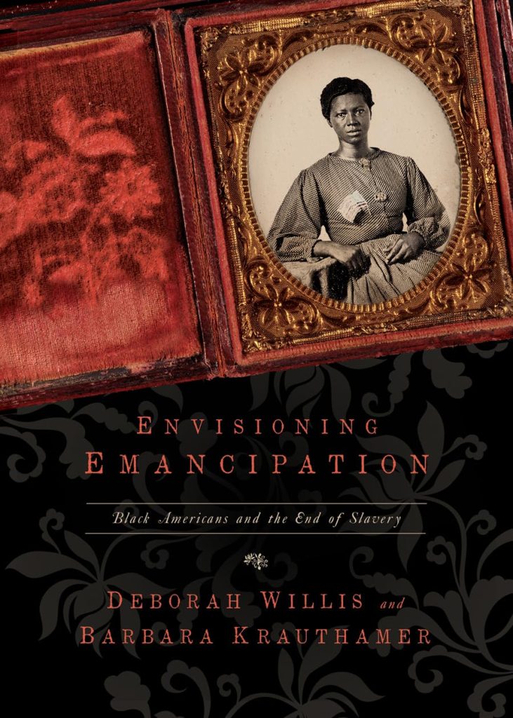 Envisioning Emancipation by Deborah Willis and Barbara Krauthamer, book cover depicting an old tintype image in a wallet frame on a black and gray ornate designed background.