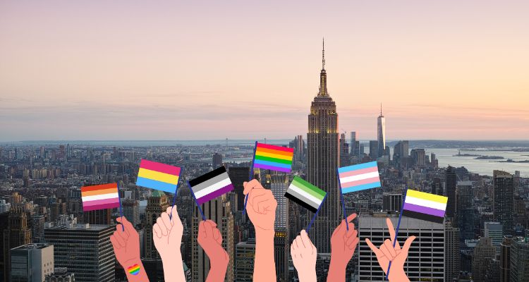 Skyline shot of New York City, showing the empire state building during sunset. Cartoon drawing of hands holding various Pride flags is at the bottom.