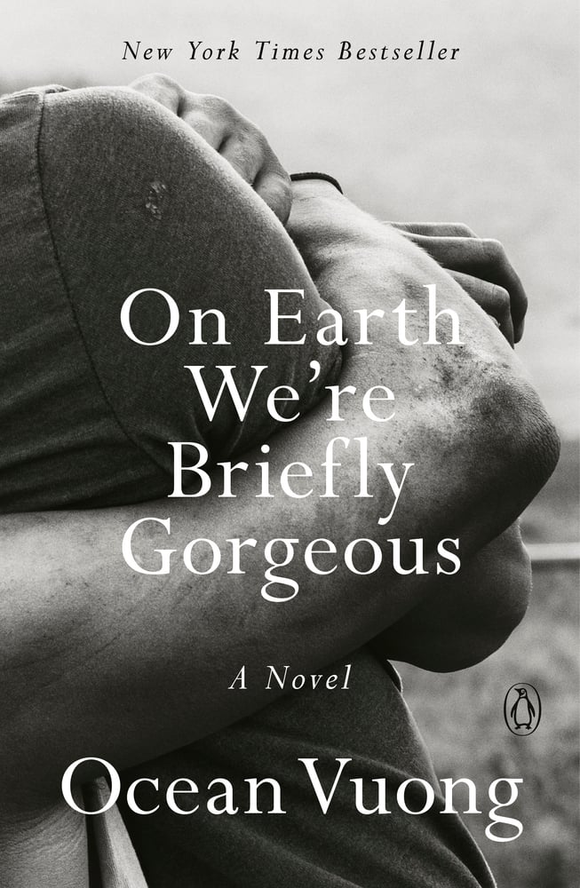 On Earth We're Briefly Gorgeous by Ocean Vuong book cover. Black and white photography of two arms in a hug.