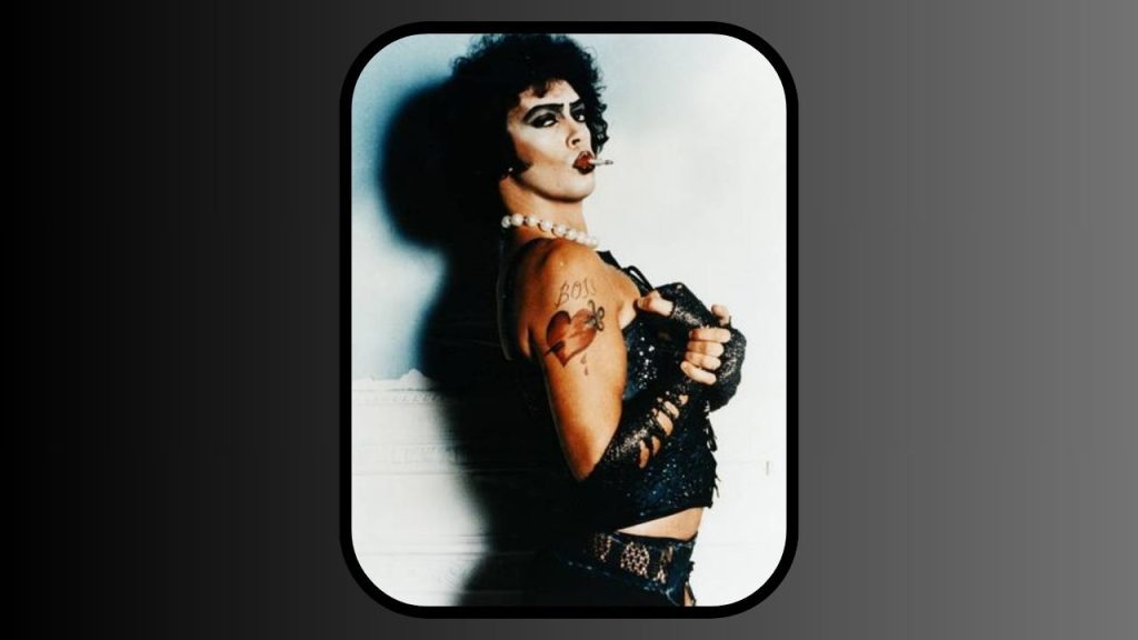 A screenshot from the film Rocky Horror Picture Show, starring Tim Curry in leather drag.