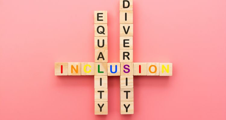 Pink background with the Scrabble letter blocks spelling out, equality and diversity. The words are parallel with the word inclusion going across it.