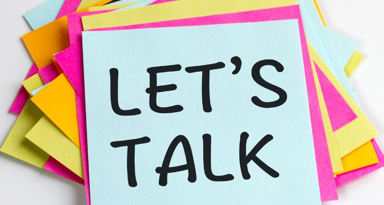 A pile of colorful sticky notes, with Let's Talk written on the top.