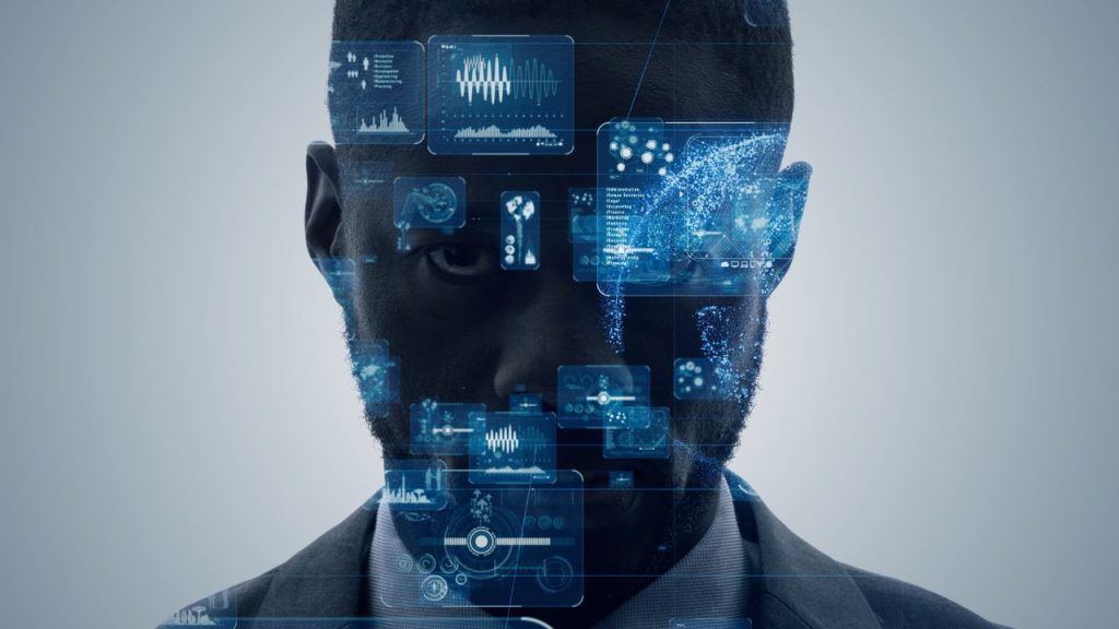 A man's silhouette with a serious expression is overlaid with blue digital data graphics, conveying a theme of technology and futuristic advancement.