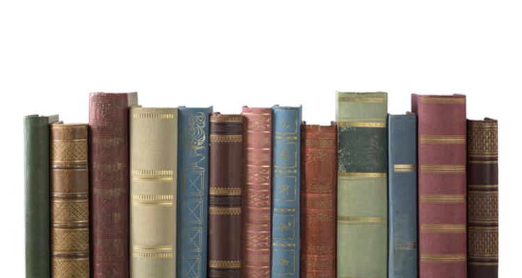 A white background, with a row of books. They are colored, leather bound, and old looking.