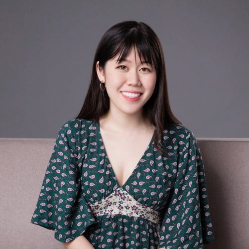 K.X. Song, author of The Night Ends with Fire, Chinese woman in a green paisley dress smiling at the camera.