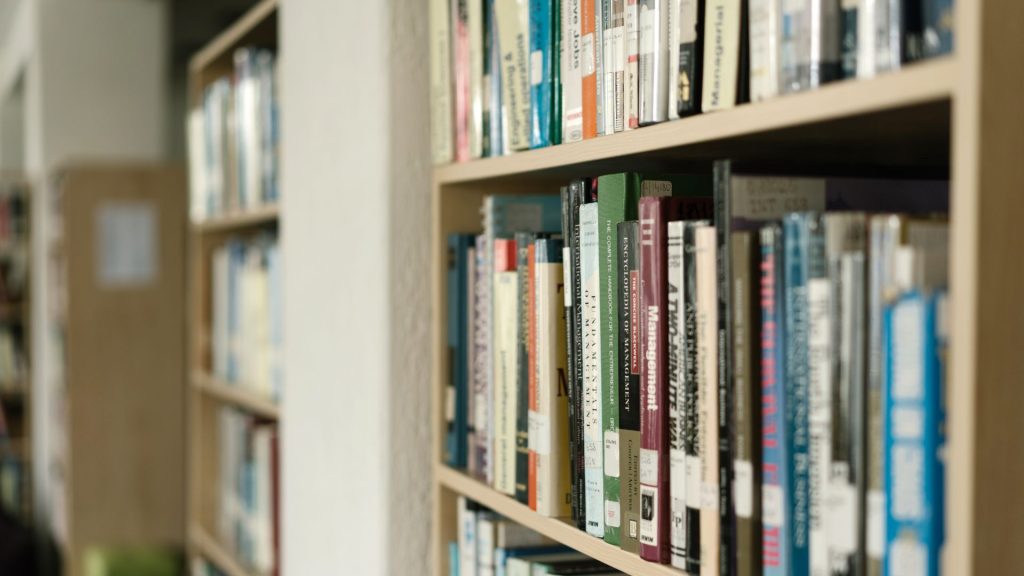 A library bookshelf filled with various titles.