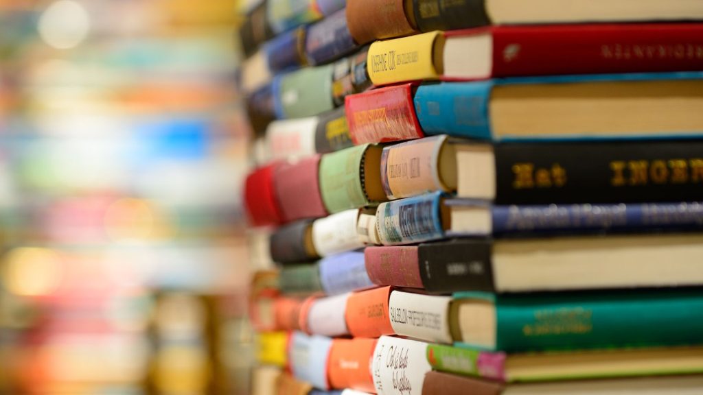 Several stacks of books in a row.