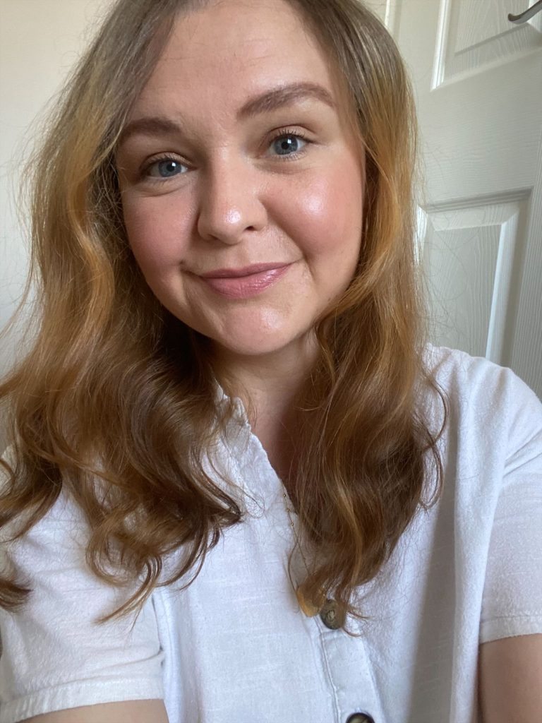 Bookstagrammer Lorna in a white shirt smiling for a selfie.
