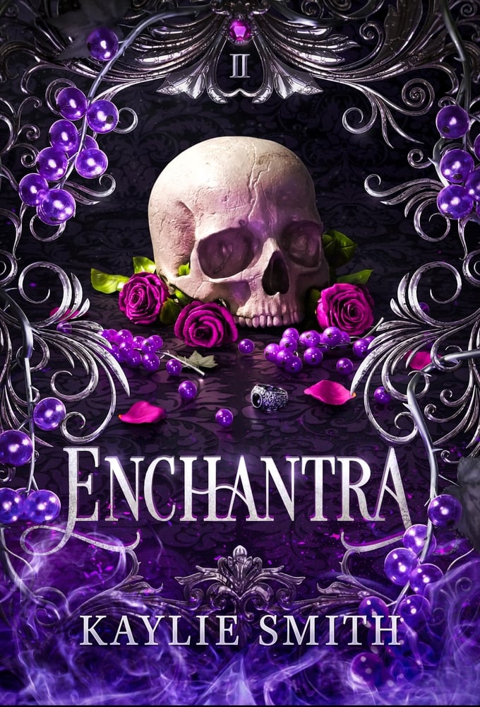 The book cover for Enchantra by Kaylie Smith. A skull and silver ring are surrounded by fuchsia roses, purple glass balls, and silver filigree accents. At the top is the Roman numeral two. At the bottom are purple flames. Enchantra is in silver lettering.