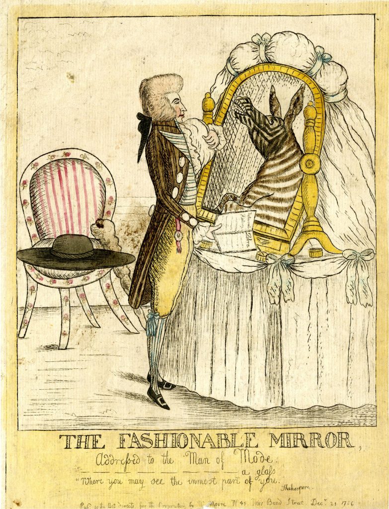 A drawing criticizing the Fop. A man in a white wig with a black bow wears an opulent brown coat, yellow trousers, and striped tights. He looks into a gold-framed mirror on a white cloth table. The reflection in the mirror is a zebra. In the background is a red and white striped chair with a black hat resting on it. Below the image, The Fashionable Mirror is in black text.