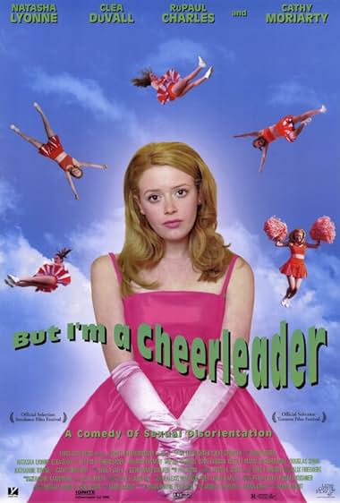 But I'm a Cheerleader movie poster by Lionsgate depicting a pretty, strawberry-blonde haired young girl in bright pink dress and baby pink ballgown gloves. She stands against a bright blue sky with the occasional white cloud. Girls in red and white cheerleading outfits and pop pops fall from the air behind her.