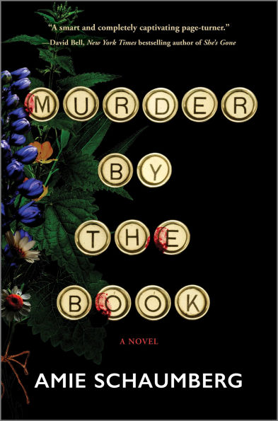 Book cover of "Murder by the Book" by Amie Schaumberg. Typewriter keys spell the title over a black background with colorful flowers.