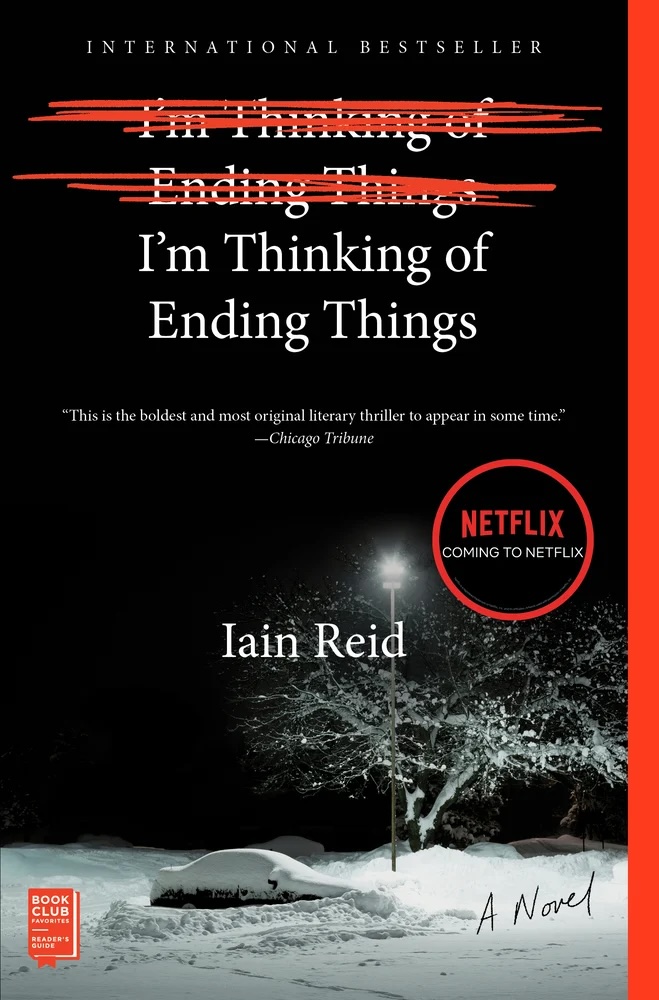 I'm Thinking of Ending Things by Iain Reid book cover, depicting a snowy floor, tree, lamp post, on a black sky. The title is written twice with one of the titles being scratched out with a red pen.