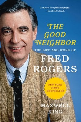 The Good Neighbor by Maxwell King book cover. Depicts Fred Rogers smiling in a tie and a tan cardigan with a blue background.