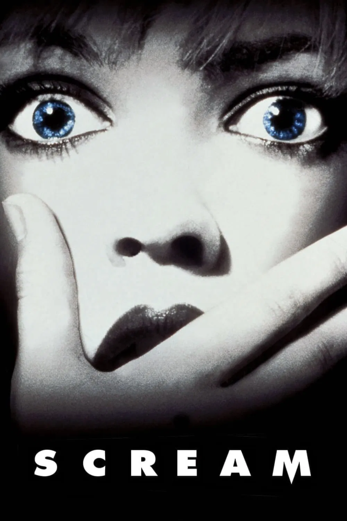 1996 Horror film Scream. Close-up image of Drew Barrymore, blue eyes are brightened whilst the rest of the image is black and white. Hand covers her mouth, eyes wide in shock.