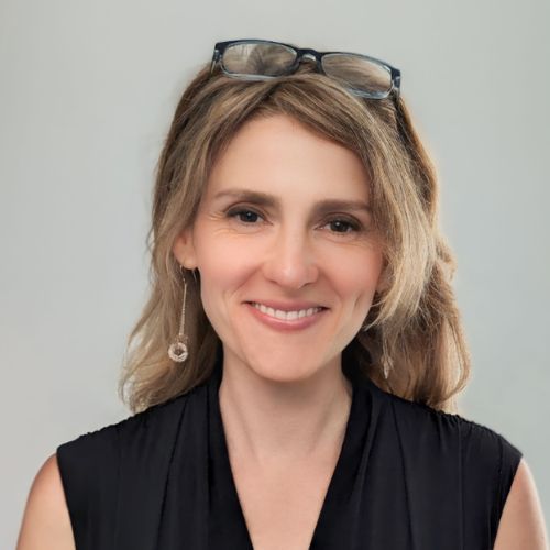 Leah Paulos, founder of Books Publicity School and Press Shop PR smiles at the camera while wearing a sleeveless black blouse with glasses nestled in her blonde hair.