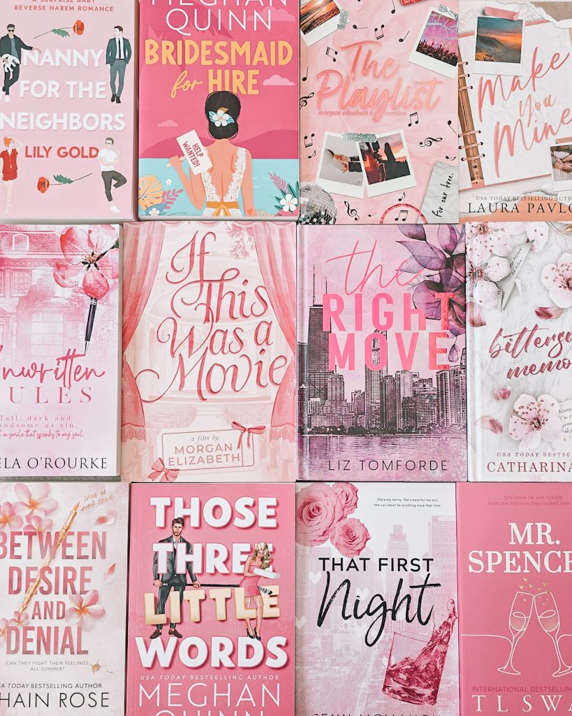 Flatlay of romance books, each with a pink color scheme, laid out flat next to each other.