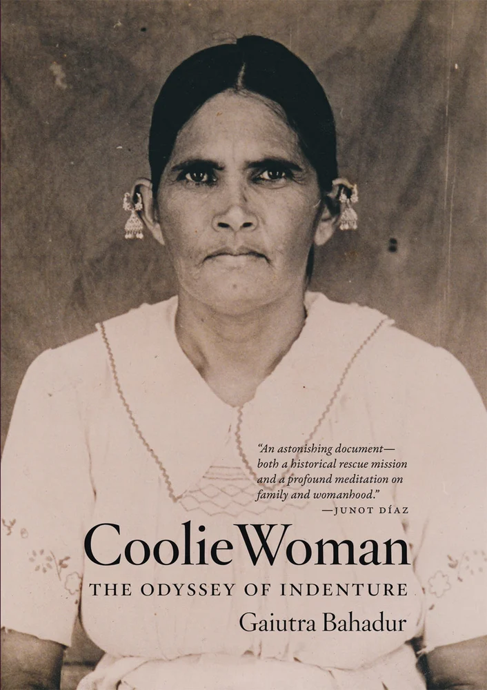 A black and white image of an Indian woman who was indentured to Trinidad. The title "Coolie Woman: The Odyssey of Indenture" by Gaiutra Bahadur is at the bottom.