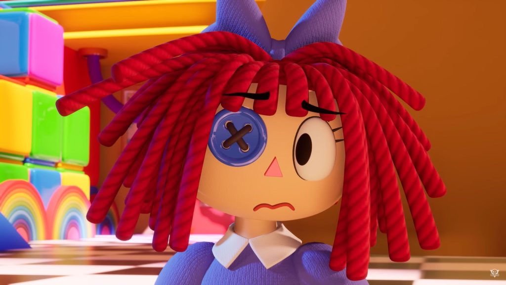 Ragatha, a rag doll with a purple bow in her red hair, purple dress, one button eye, and one normal eye, looks anxiously off to the viewer's left. Brightly colored blocks and rainbows can be seen standing on the black and white tiled floor in the background.
