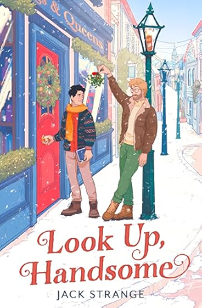 Look Up, Handsome by Jack Strange book cover featuring two men looking at each other. One is holding up a mistletoe between them while the other is opening the door to a shop. The background depicts a small, colorful town, and the title is in red letters at the bottom.