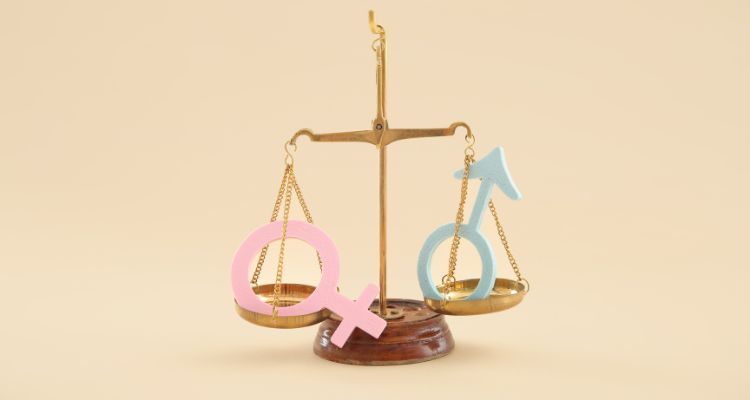 Scale with the two gender symbols set as equals on a tan background.
