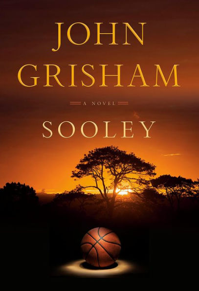 Book cover of "Sooley" by John Grisham. A basketball sits in front of trees against a vibrant orange sunset.