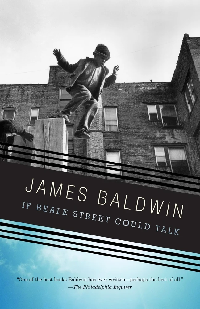 If Beale Street Could Talk by James Baldwin book cover of a black and white image of a young boy jumping off a ledge with a brick building behind him.