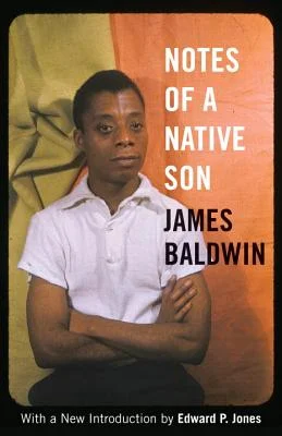 Notes of a Native Son by James Baldwin book cover of young James Baldwin in a white shirt sitting with his arms crossed with a yellow and orange background.