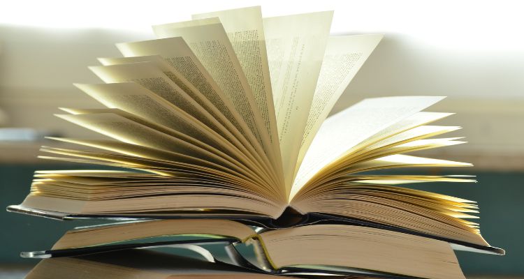 Depicts a book with the pages fanned out.