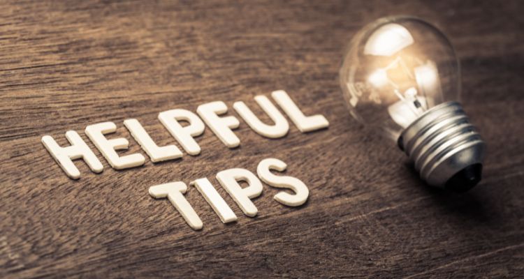 Depicts the words "Helpful Tips" on a wooden background with a lightbulb beside it.