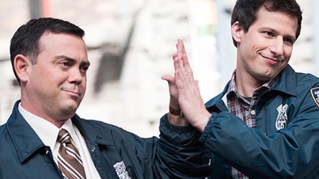 Jake and Charles candidly high-five, smug smiles on their faces as their chaotic unity needs no explanation.