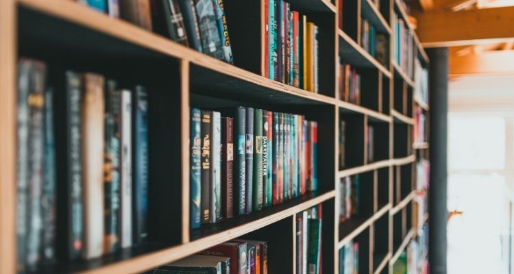 Depicts an angled perspective of a bookshelf in a bookstore.