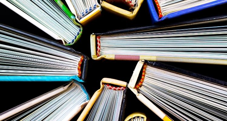Depicts an overview of the tops of 9 books.