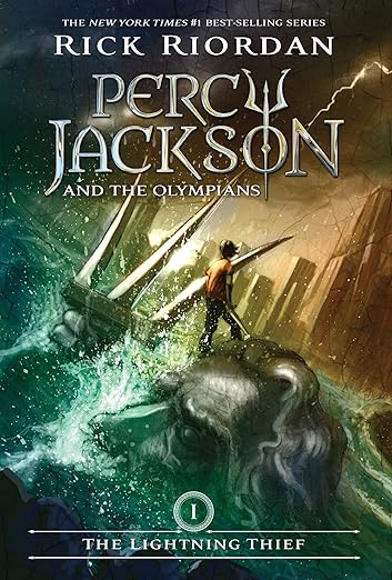 Percy Jackson and the Olympians: The Lightning Thief book cover, depicting a boy standing on the forehead of a large silver head that is next to a silver trident. The head is submerged in water and in the background is a diagonal city skyline.
