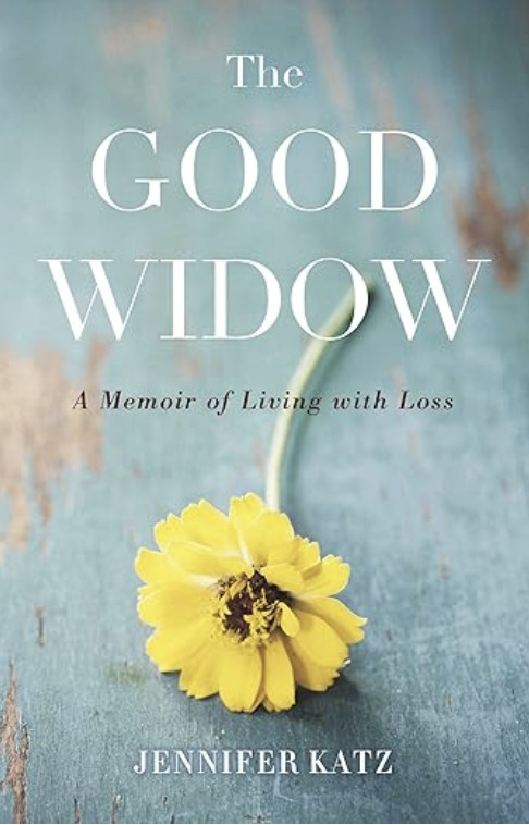 The Good Widow: A Memoir of Living with Loss by Jennifer Katz. The design shows a single yellow flower with a bent stem lying flat against a rustic blue wooden surface.