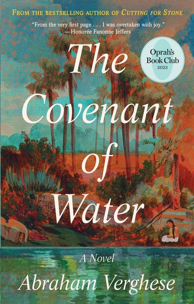 The Covenant of Water by Abraham Verghese book cover. Depicts a coast with foliage on the bank and tall palm trees.