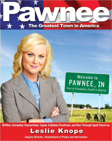 Book cover of "Pawnee: The Greatest Town In America" by Leslie Knope. Leslie Knope in a gray blazer smiles confidently. Next to her is a "Welcome to Pawnee, IN" sign.