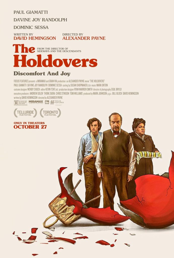 The Holdovers by Alexander Payne movie poster depicting three people behind a smashed red Christmas bauble on a very light pink background.