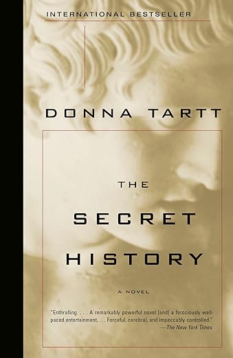 The Secret History by Donna Tartt book cover, depicting a close-up, beige image of a male sculpture looking downwards. The title is in black text and surrounded by a thin, red rectangle.