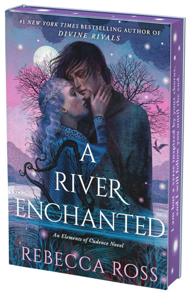 Deluxe collector’s edition of “A River Enchanted” by Rebecca Ross. The illustrated cover features a romantic scene of two characters embracing under a starry purple-blue sky, with bare trees and a glowing moon in the background. The edition has purple sprayed edges with stenciled designs.