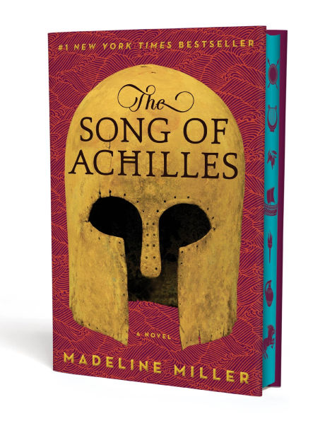 Deluxe edition cover of “The Song of Achilles” by Madeline Miller. The design features a golden ancient Greek helmet against a maroon patterned background, with the title in bold black letters and teal sprayed edges visible along the side.