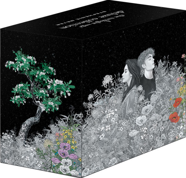 Side view of “The Twilight Saga” deluxe boxed set, illustrated with Bella and Edward in grayscale among blooming wildflowers, with a tree to the left and a starry night sky above.