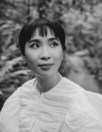 Professional headshot of Ling Ling Huang, a woman with dark hair wearing a white top, looking to the right with a slight smile.
