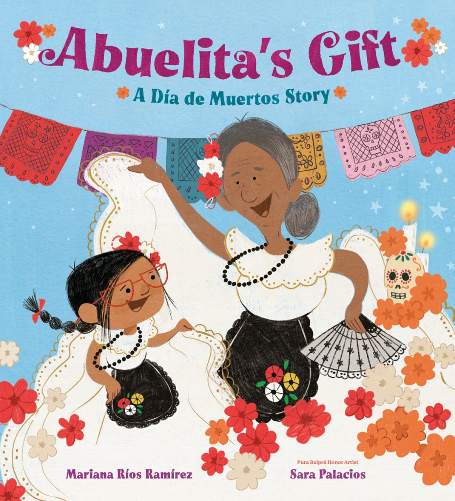 Abuelita's Gift: A Día De Muertos Story by Mariana Rios Ramirez and Sara Palacios depicts a grandmother and her granddaughter surrounded by flowers, dancing with a string of flags over their heads.