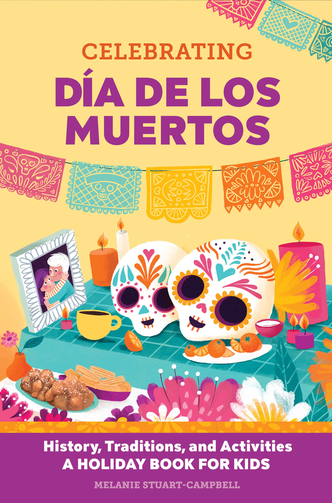 Celebrating Día de Los Muertos by Melanie Stuart-Campbell depicts a table set with two sugar skulls, a frame of two older relatives, food, candles, and flowers. Above the table is a set of flags below and above the title.