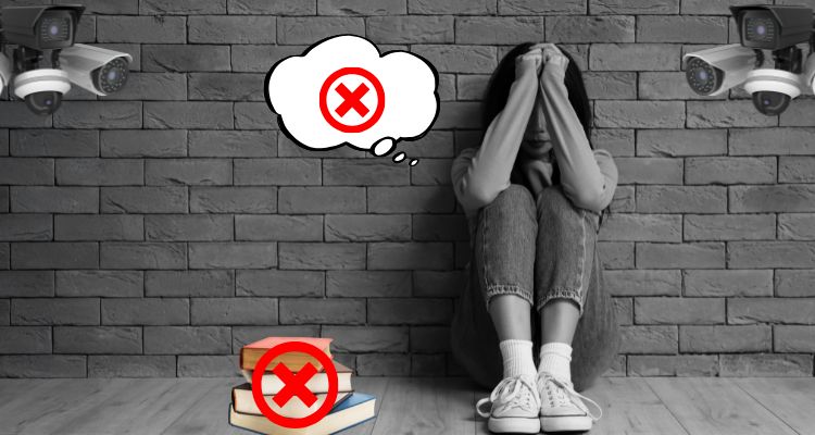 Woman sitting against a brick wall, knees up, head resting against her clasped fist. There are surveillance cameras in the corners. Though bubble and stack of books with red X's covering them.