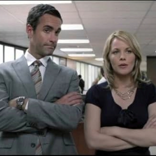 TV still from Better Off Ted, featuring Ted and Linda, with their arms folded.