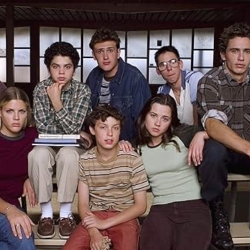 The original cast of Freaks and Geeks, sitting on stairs.