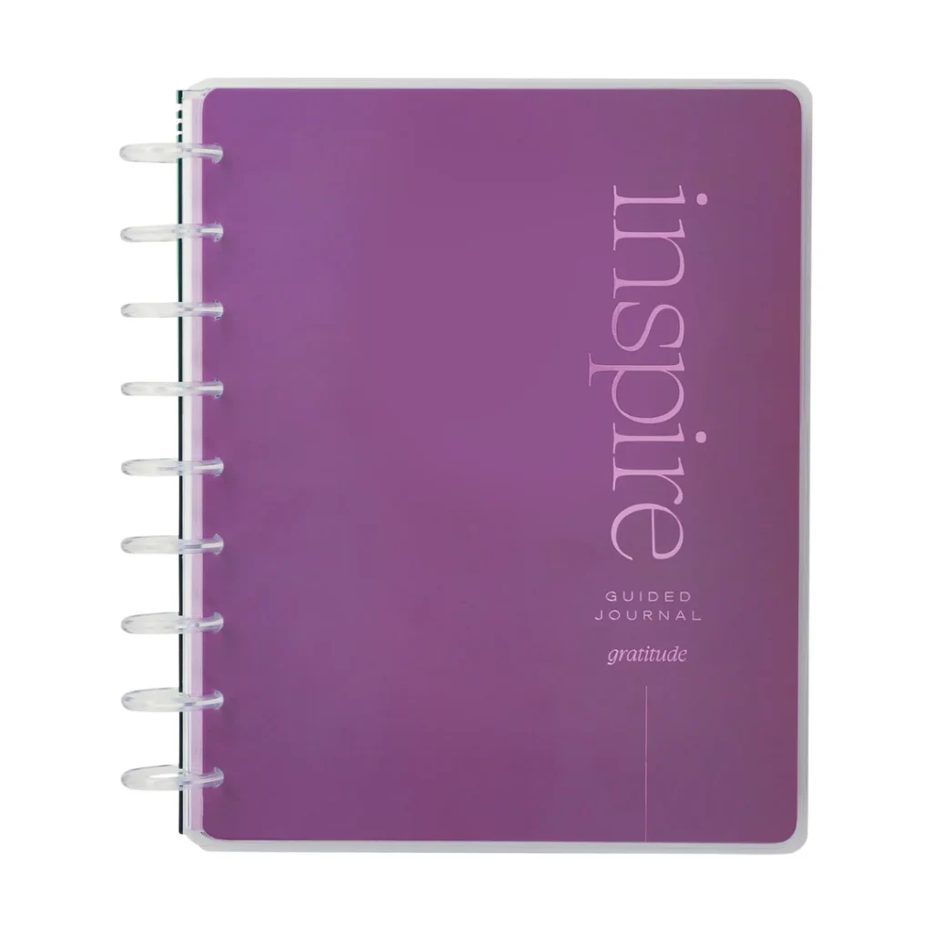 The Reflect & Grow Guided Gratitude Journal by the Happy Planner with the word "Inspire" vertically in large font on the side with "guided journal" and "gratitude" horizontally underneath it against a purple background.